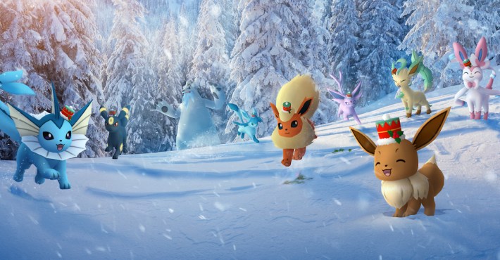 Key art of Eevee and its evolutions wearing holiday hats in the snow, with a Beartic in the background