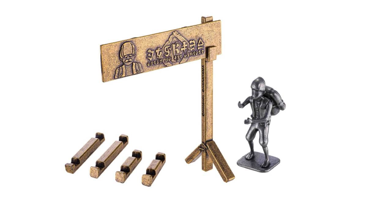 The two new Legend of Zelda Huzzle Puzzles feature Addison holding the Hudson Construction sign and the Hylian Shield.