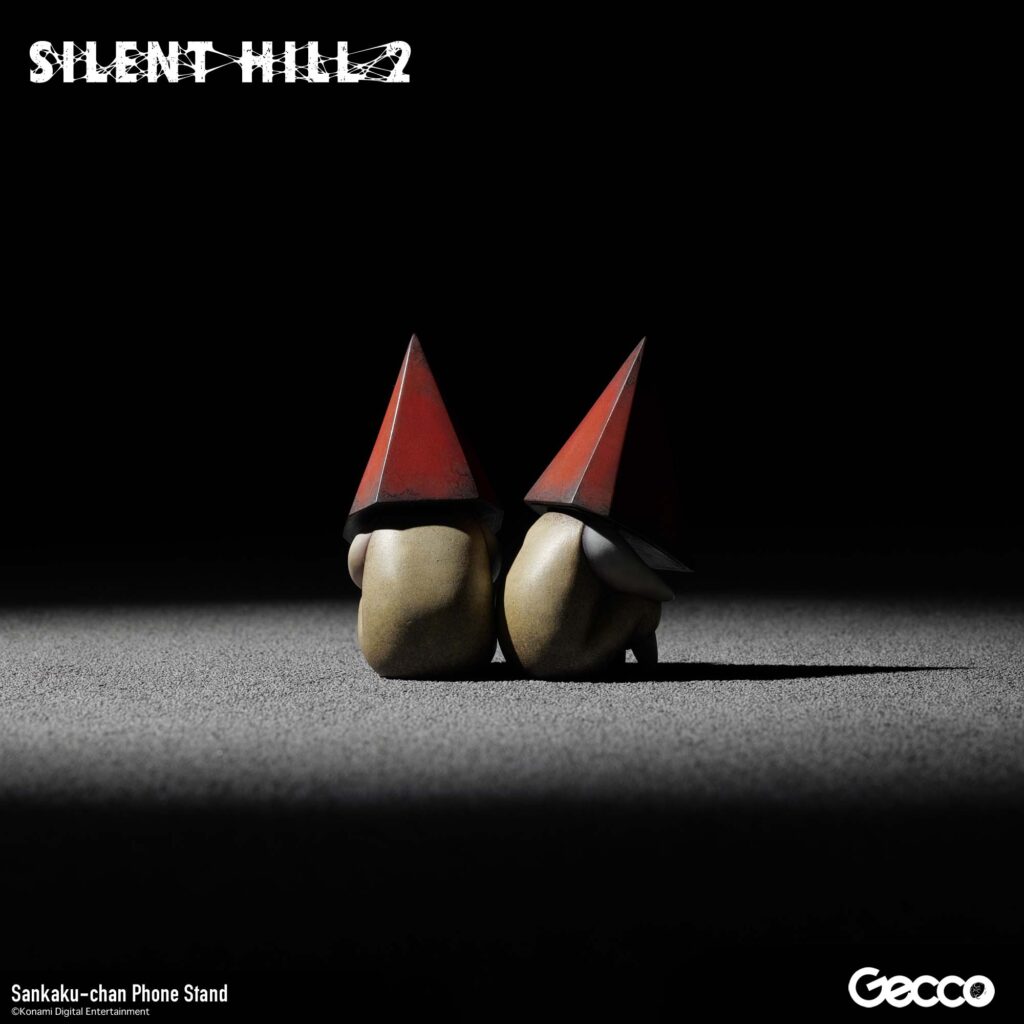 The next Gecco Silent Hill 2 merchandise will be a Sankaku-chan phone stand with two tiny red Pyramid Head figures. 